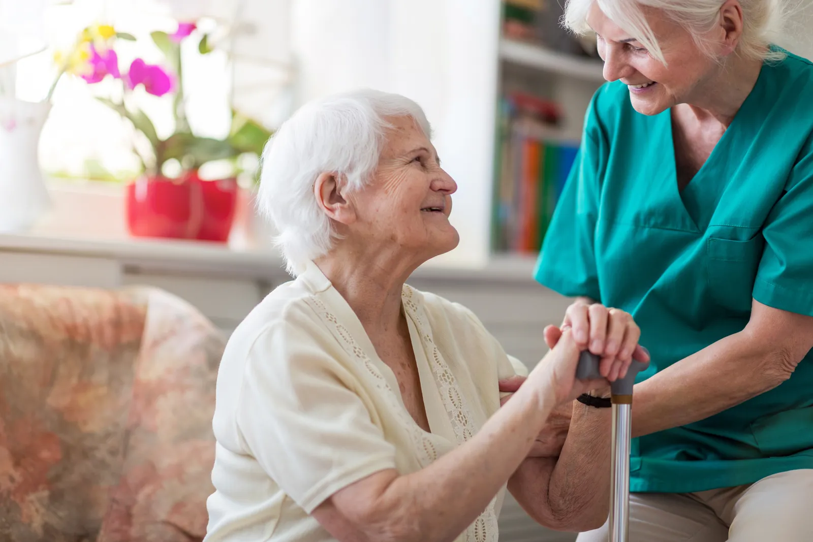 Support worker sharing a friendly moment with an older person at home